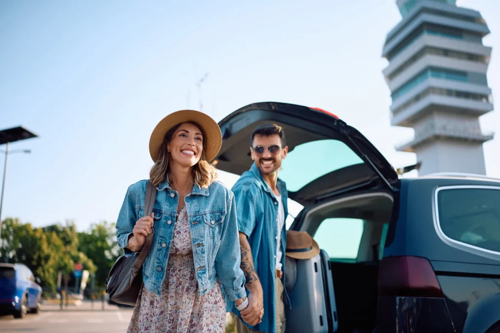 Tourists picking up their rental car at Rhodes Airport RHO with luggage.